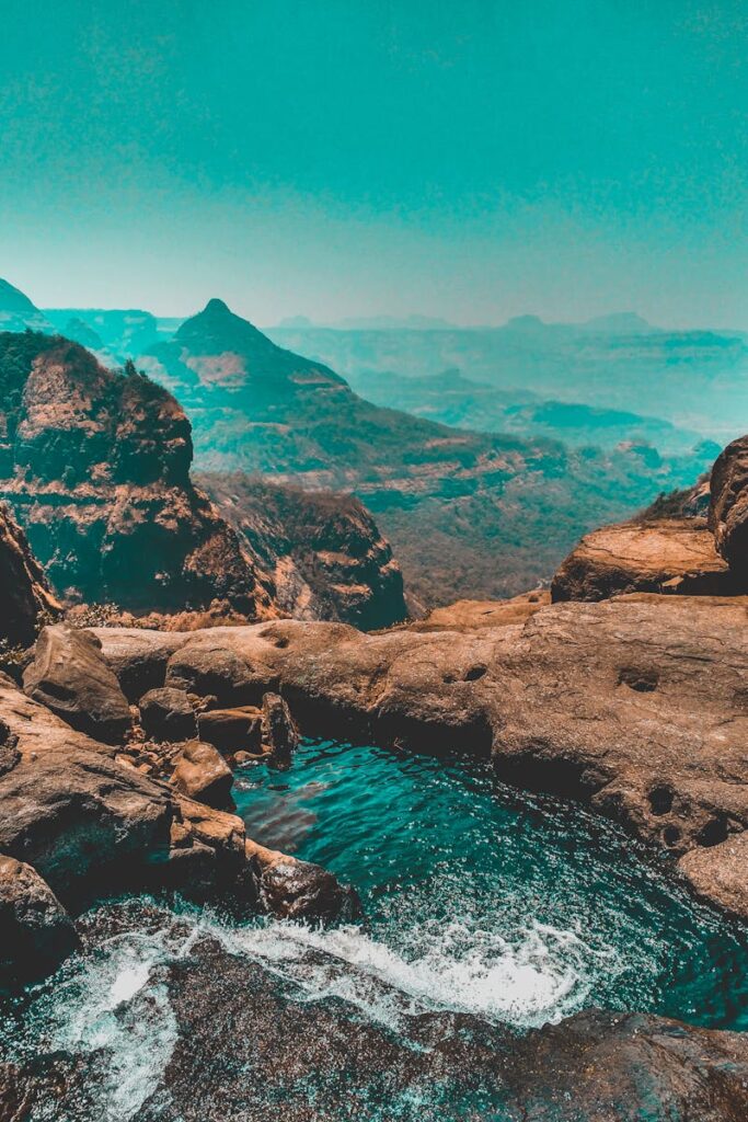 Stunning view of a mountain landscape with a scenic waterfall and vibrant sky.